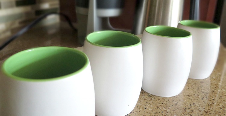 Spruce up old coffee mugs with this easy DIY! All you need is your favorite spray paint color and paint tape. Use as a gift or for everyday cup of coffee!