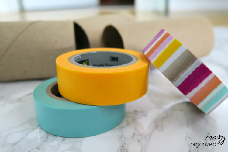 Surprising way to use toilet paper rolls to organize cords! Add a little washi tape for a bunch of color to this easy organizing trick!