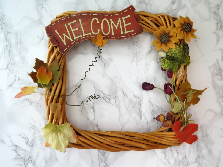 Skip buying the expensive wreaths when you can up-cycle an affordable one from a thrift store! See my transformation of a fall to spring wreath!