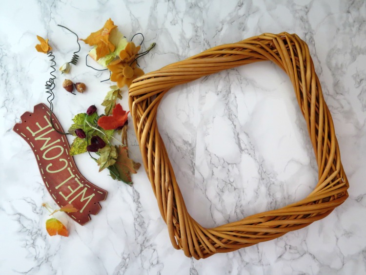Skip buying the expensive wreaths when you can up-cycle an affordable one from a thrift store! See my transformation of a fall to spring wreath!