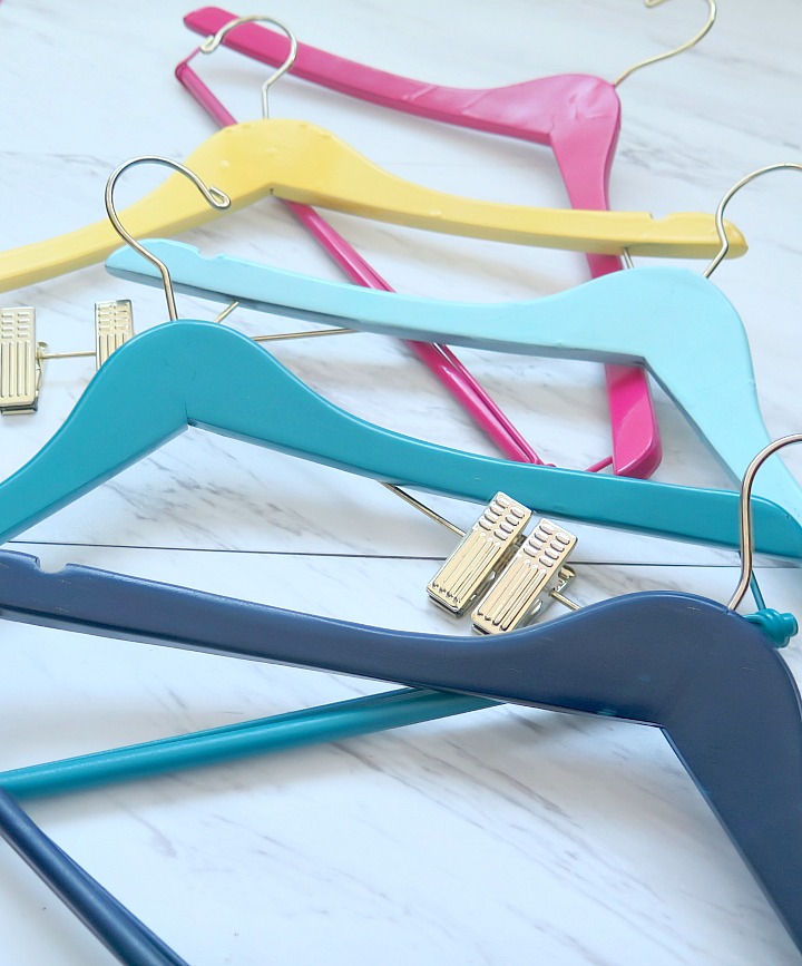 DIY painted wooden hangers make a fun and decorative splash of color!