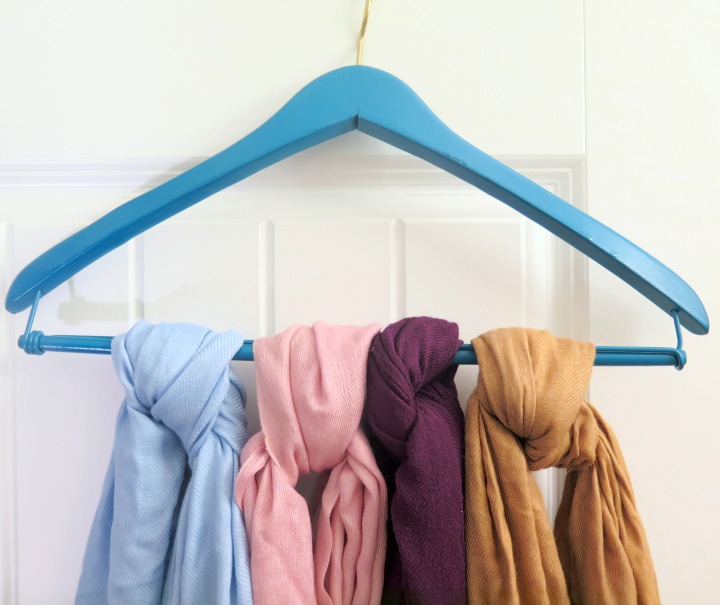 Use a painted wooden hangers to hold scarves!