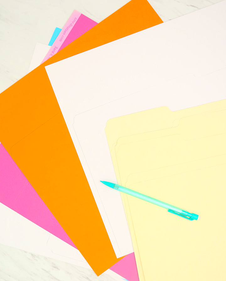Read this easy tutorial for colorful DIY file folders to keep ALL your paper clutter organized! I keep these in our command center and add a label to each!